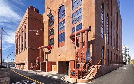 An orange-red factory as seen from its corner