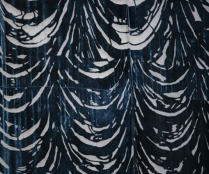 A tall, oversized black and white artwork resembling curtains